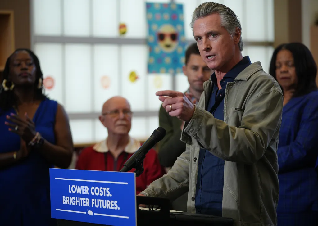 Governor Newsom speaking at a podium with 