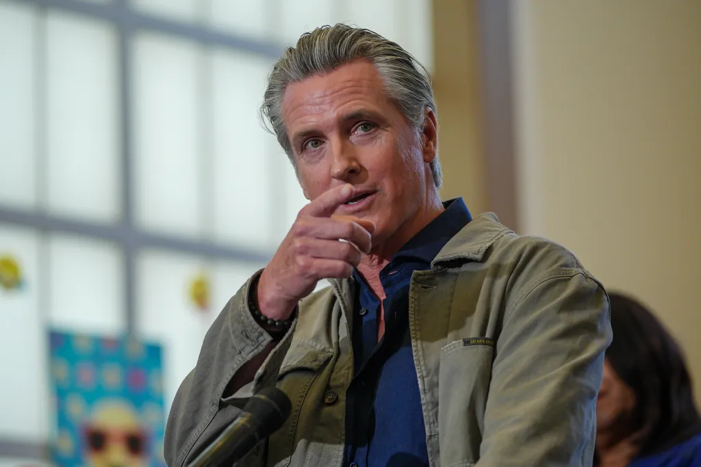 Governor Gavin Newsom speaking into a microphone.