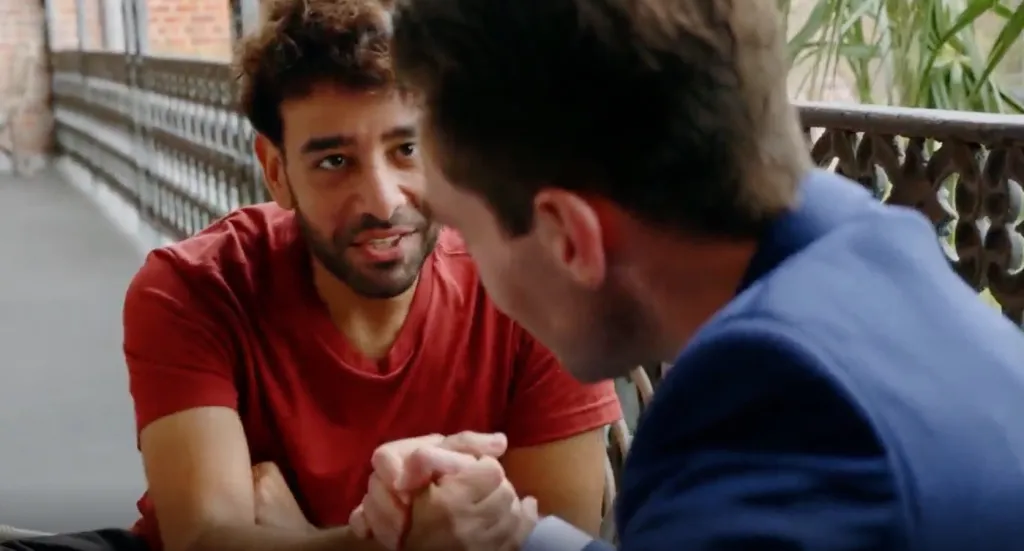 Two men arm wrestling.