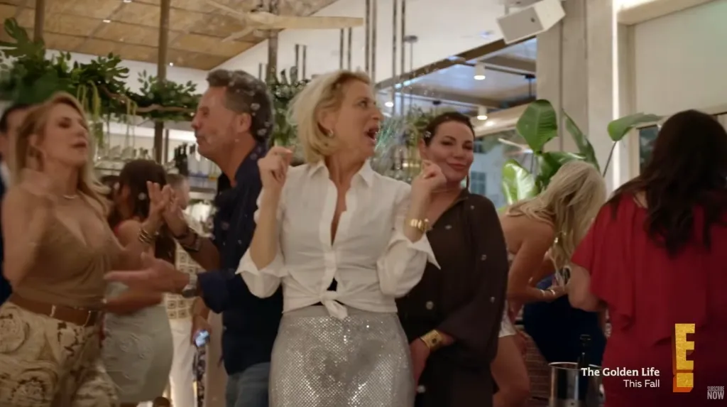 People dancing with confetti falling from above.