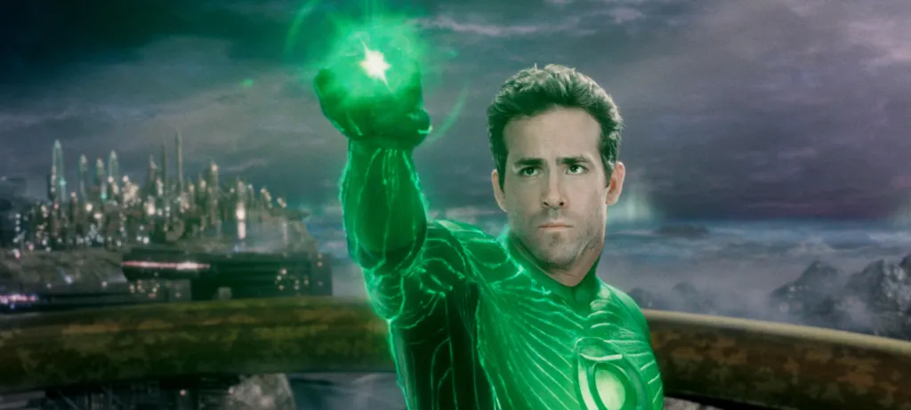Ryan Reynolds as Green Lantern, with his arm raised and a green glow emanating from his hand, against a city backdrop.