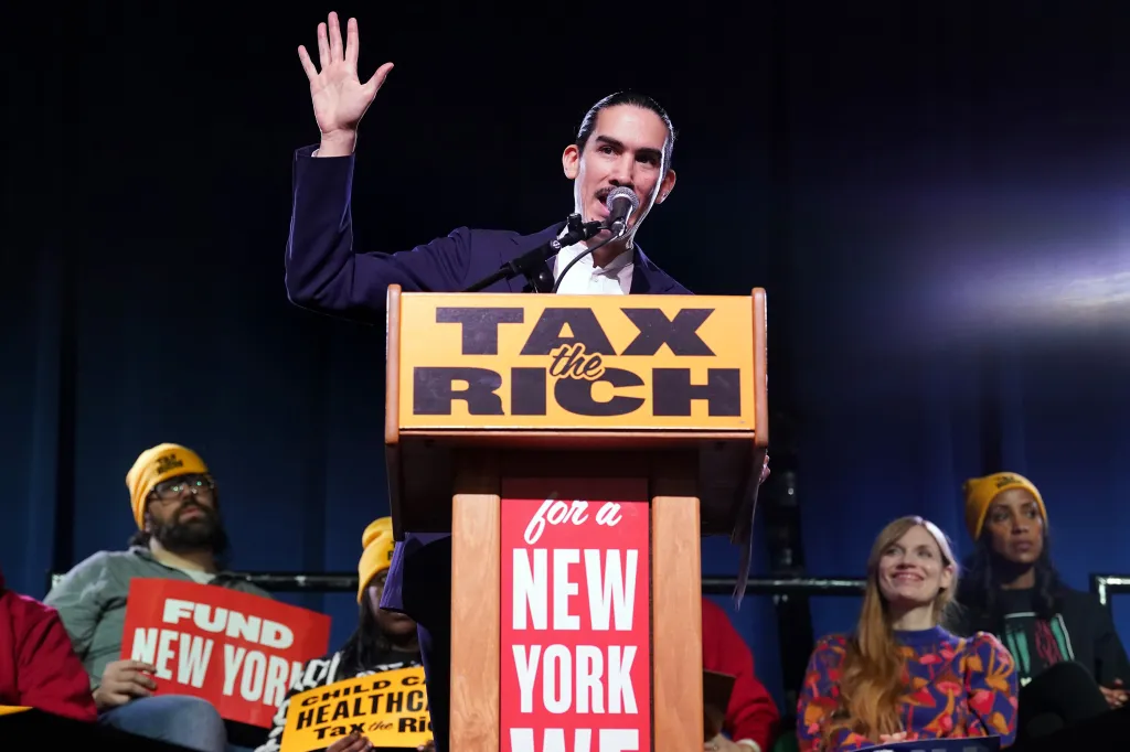 Gustavo Gordillo speaks at a podium with 