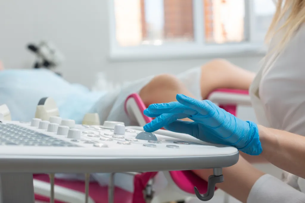 A gynecologist performing an ultrasound diagnostic procedure.