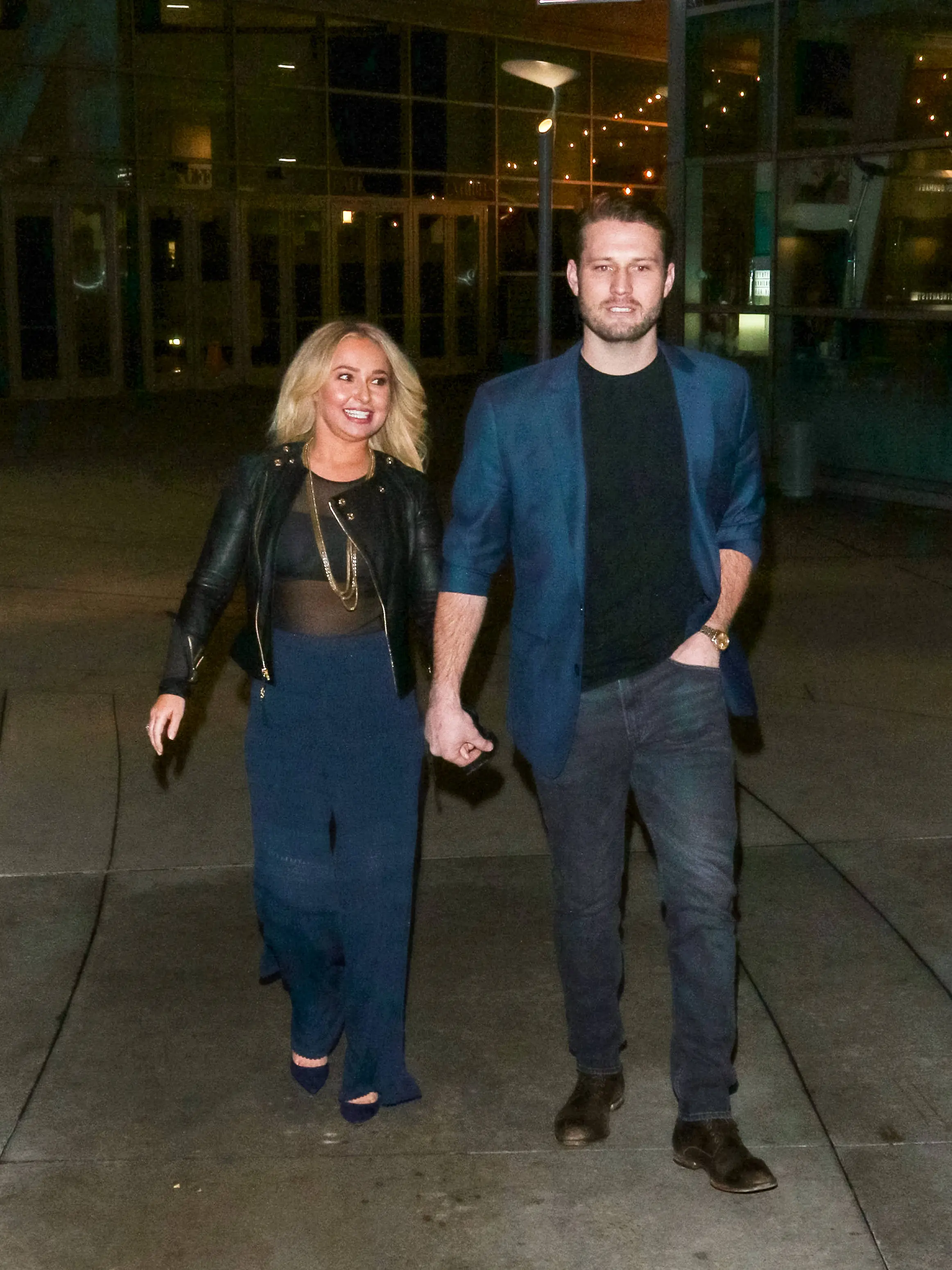 Hayden Panettiere and Brian Hickerson hold hands while walking together at night.