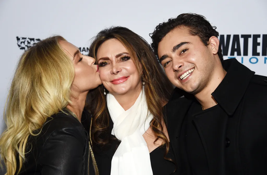 Hayden Panettiere kissing Lesley Vogel on the cheek, with Jansen Panettiere smiling next to them at the Sharkwater Extinction screening.