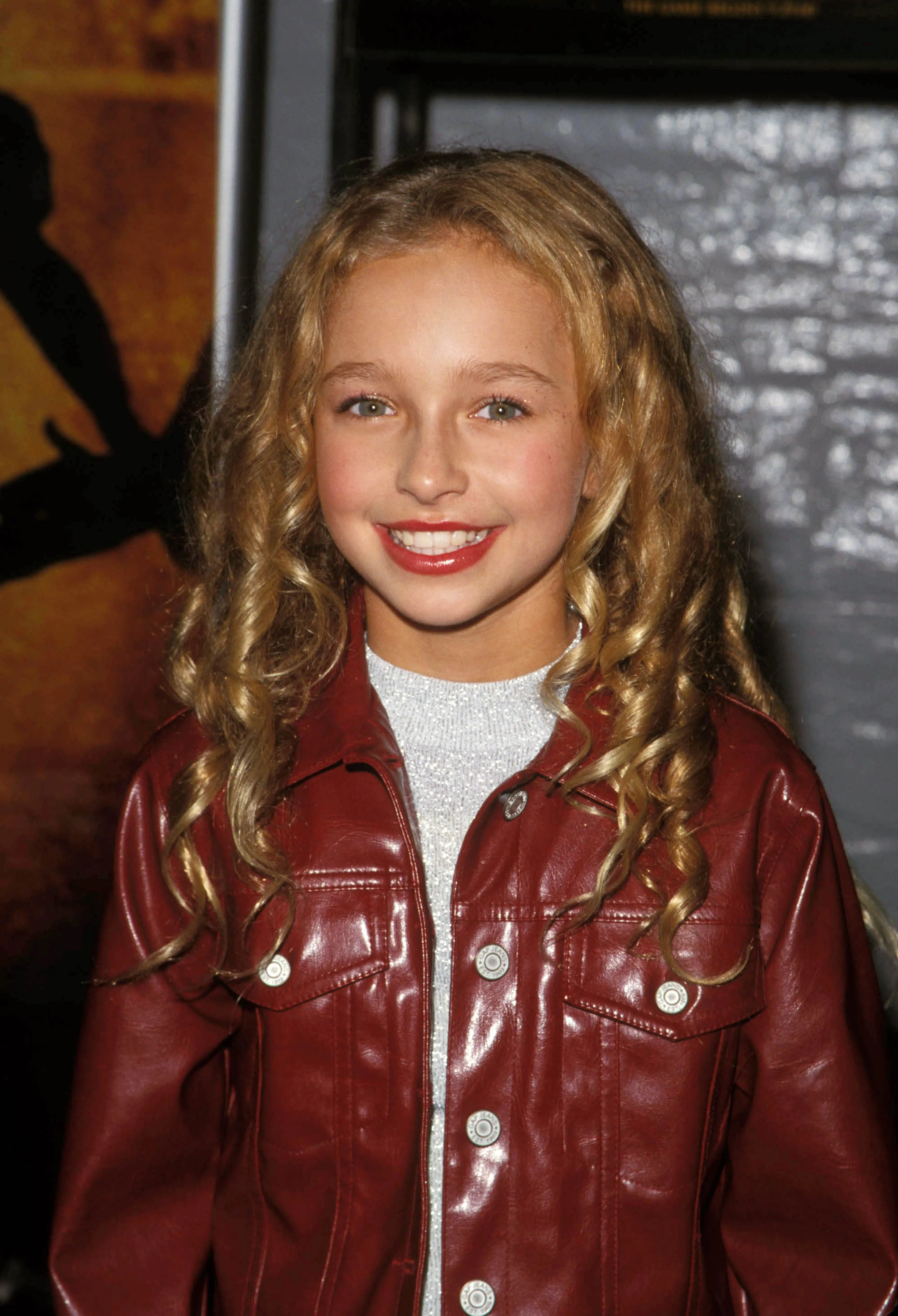 Hayden Panettiere wearing a shiny red jacket and a silver top.