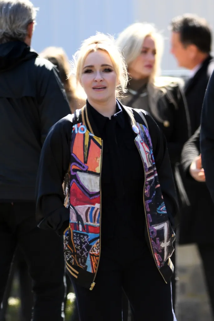 Hayden Panettiere in a black shirt and painted jacket.