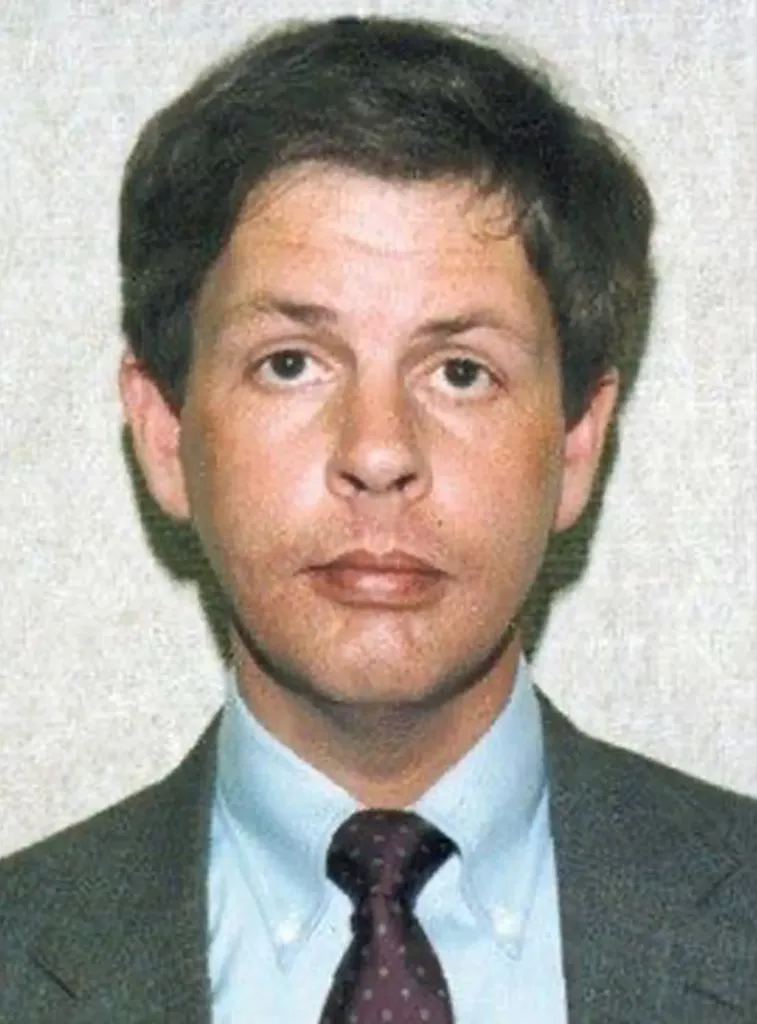 Mugshot of Herb Baumeister, a man with brown hair, in a gray suit and patterned tie.