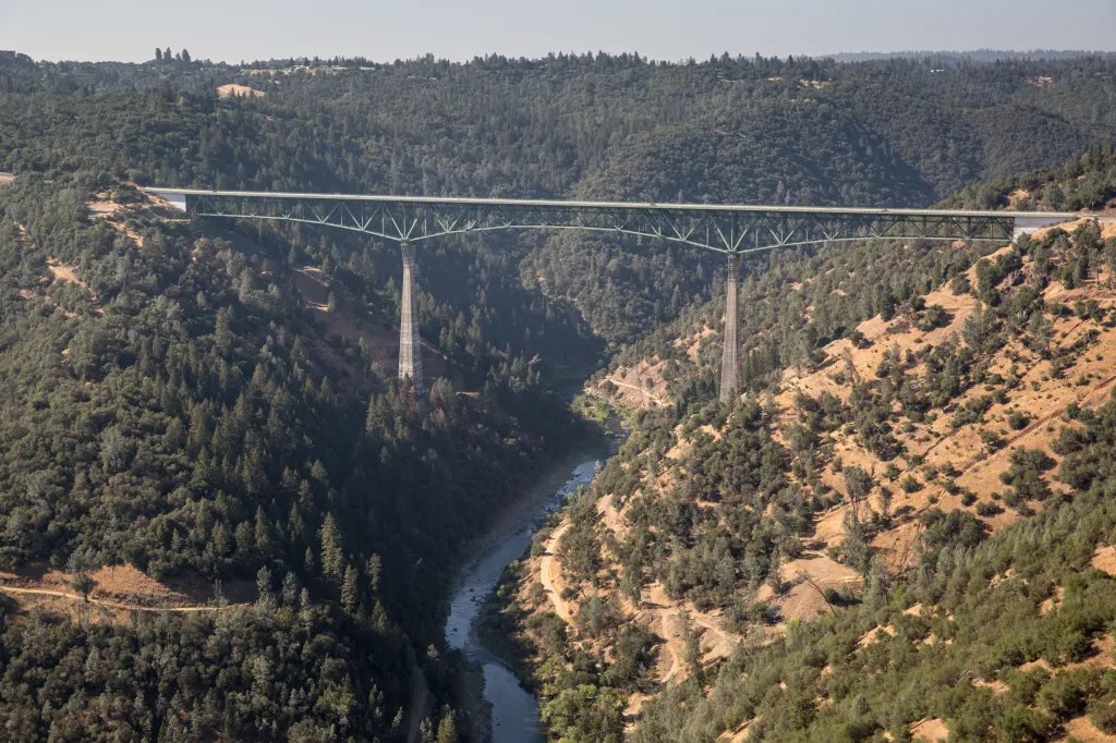 Aerial view of the Foresthill Bridge spanning a river canyon in California's Gold Country.
