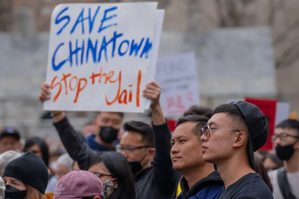 Protesters holding a sign that reads 