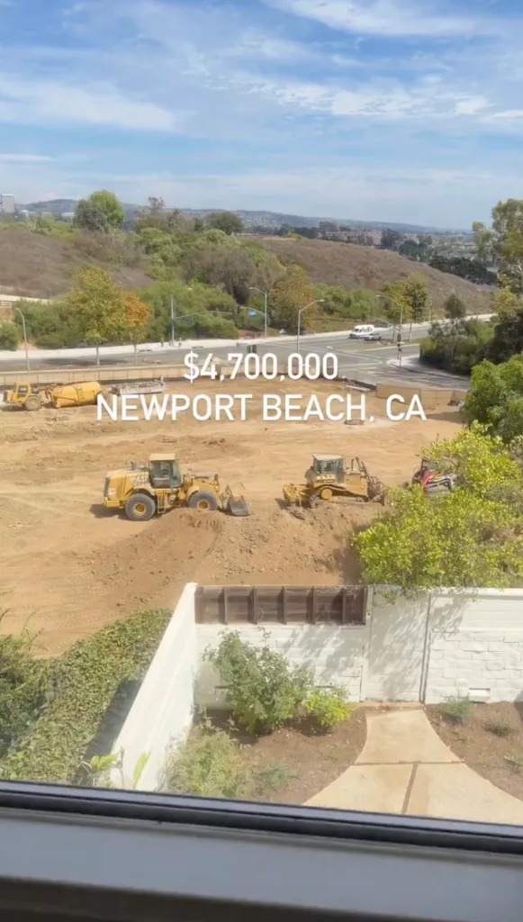 A construction site in Newport Beach, California, priced at $4,700,000, with a view of a road and hills in the background.