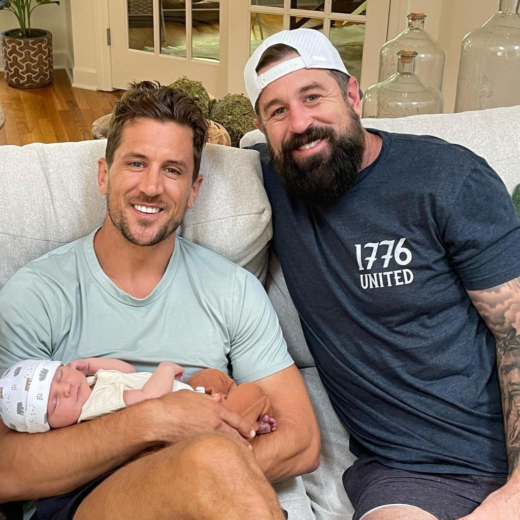 Jordan Rodgers holding a baby, next to Luke Rodgers.