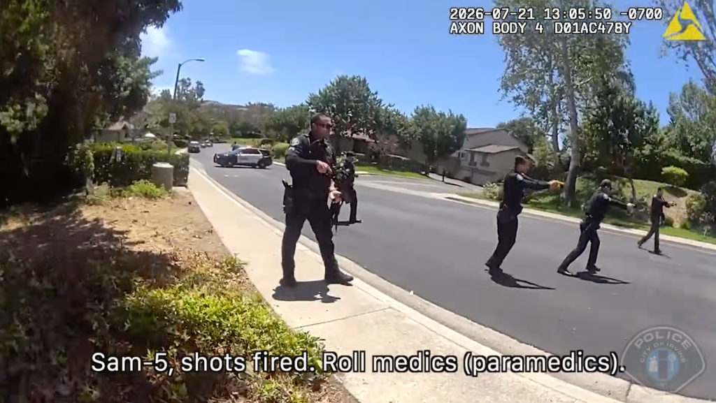 Bodycam footage showing several police officers with weapons drawn in a residential street.