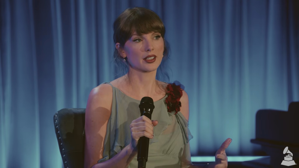 Taylor Swift speaking into a microphone.