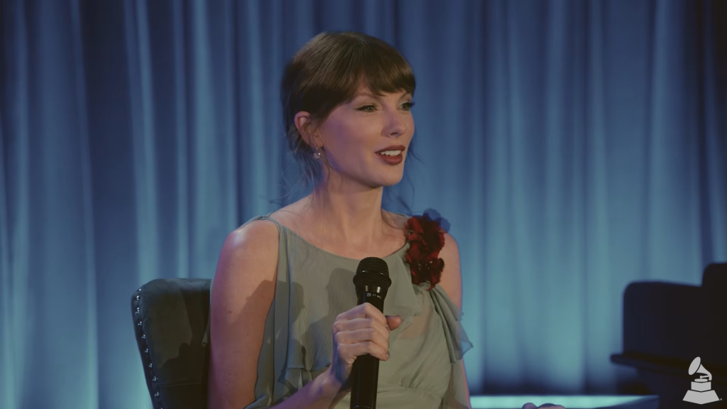 Taylor Swift speaking into a microphone.