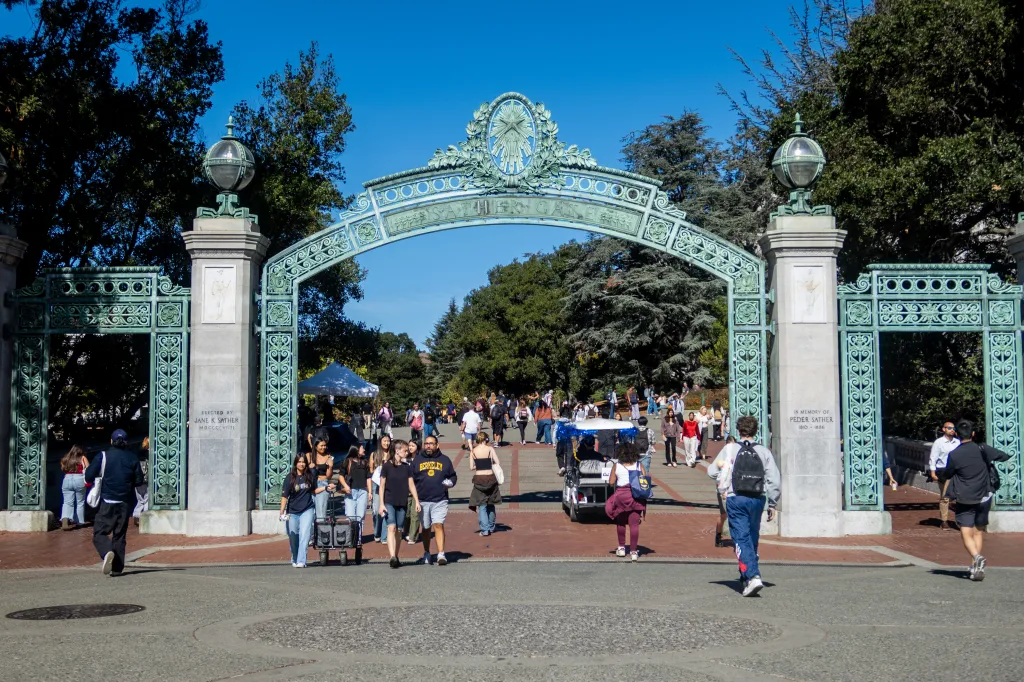 Students walk under Sather Gate at the University of California, Berkeley.