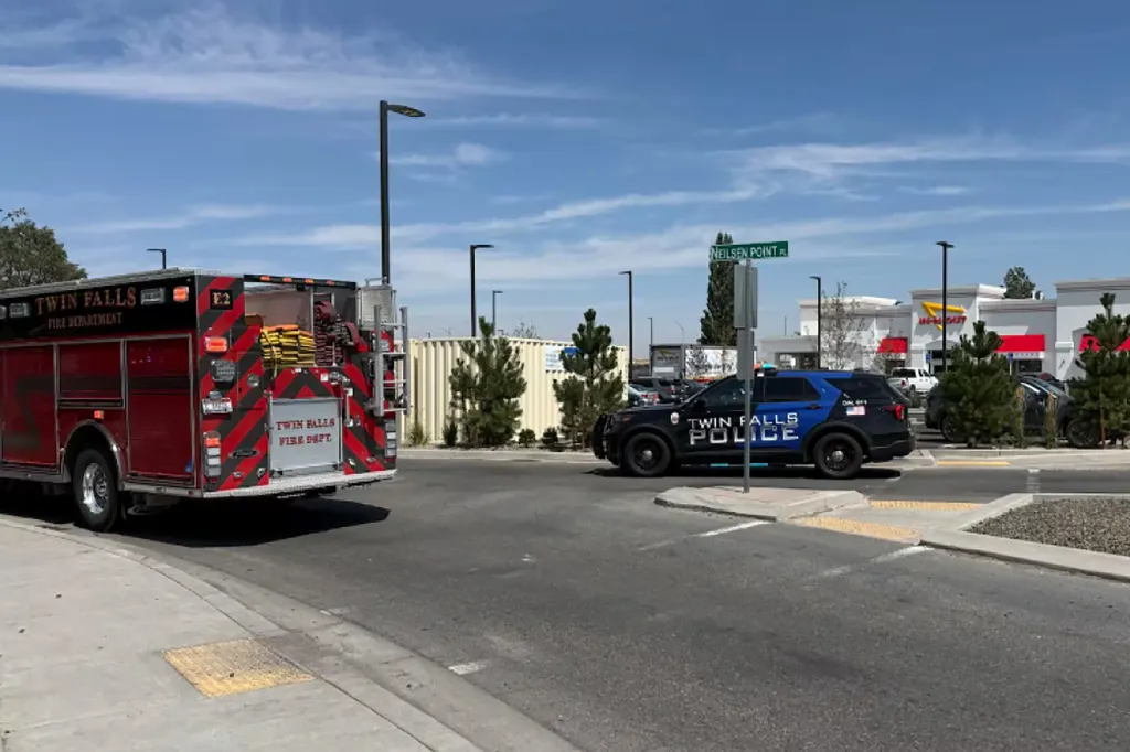 A Twin Falls Fire Department truck and Police car are at the scene of a shooting outside an In-N-Out Burger restaurant.