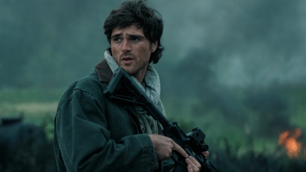 Jacob Elordi holding a rifle in a scene from 