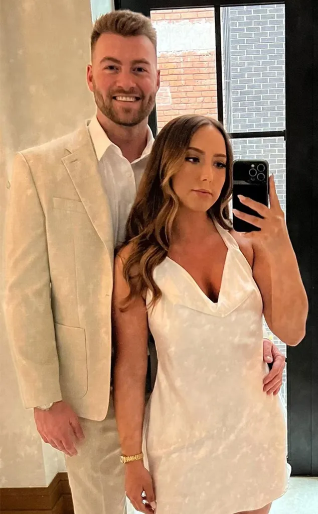 Hailie Jade and Evan McClintock standing together at their engagement party.