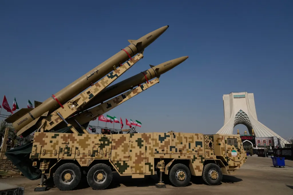 Two Iranian missiles on a military vehicle displayed in front of the Azadi Monument.