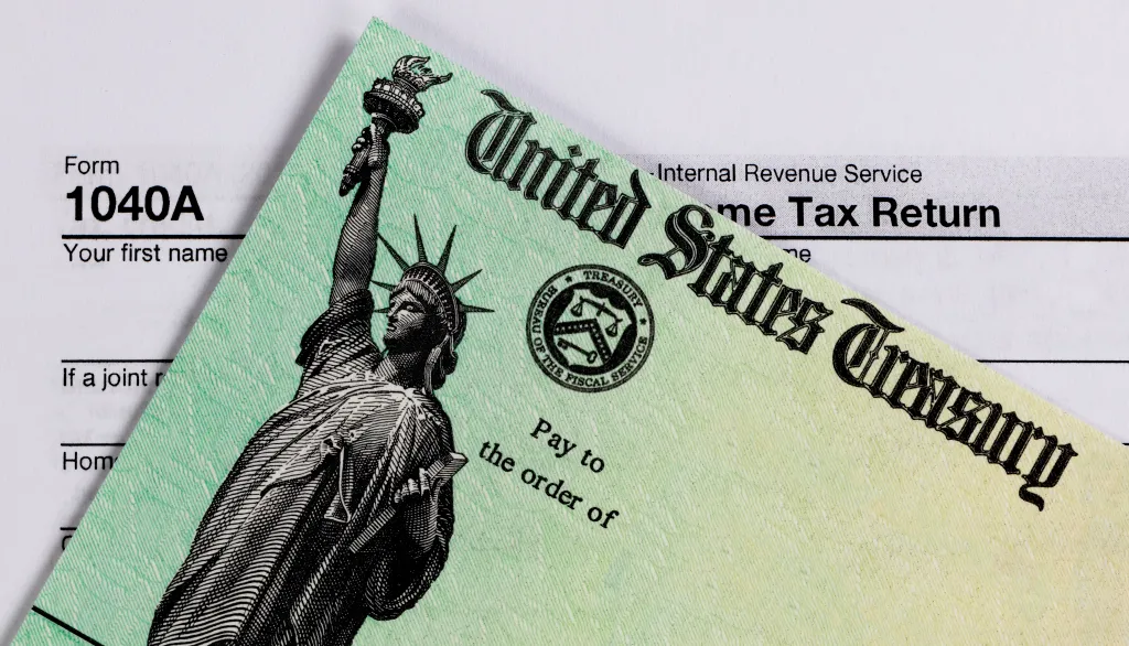 Close-up of an IRS refund check and a Form 1040A tax document.