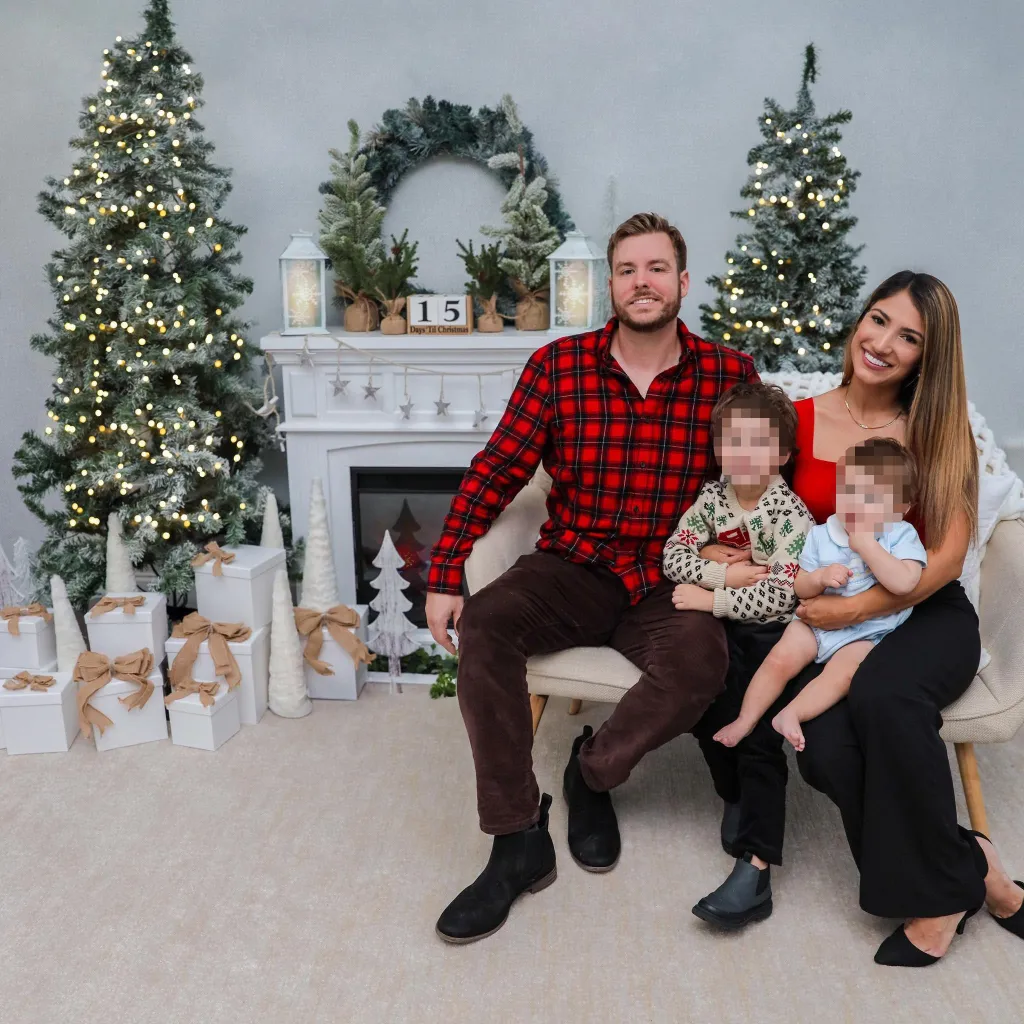Jake and Eliana Bigoni pose with their two young children for a Christmas photo.