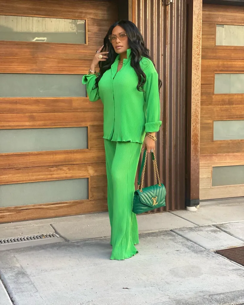 Jen Shah in a bright green pleated top and matching wide-leg pants, with a green quilted purse.