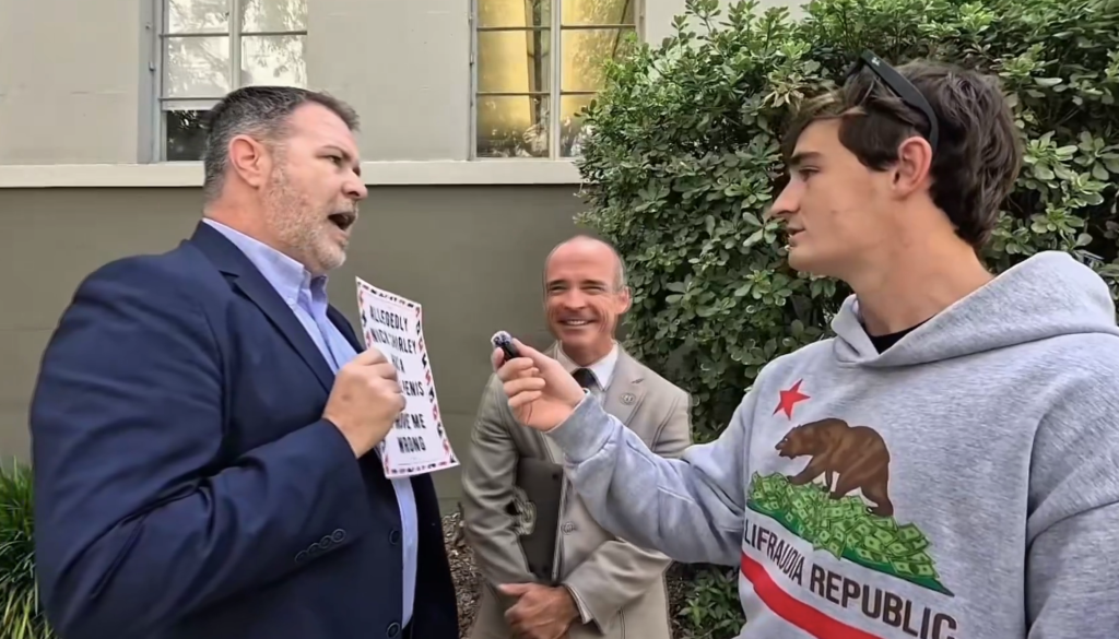 Jerry Schanz holding a sign that reads 