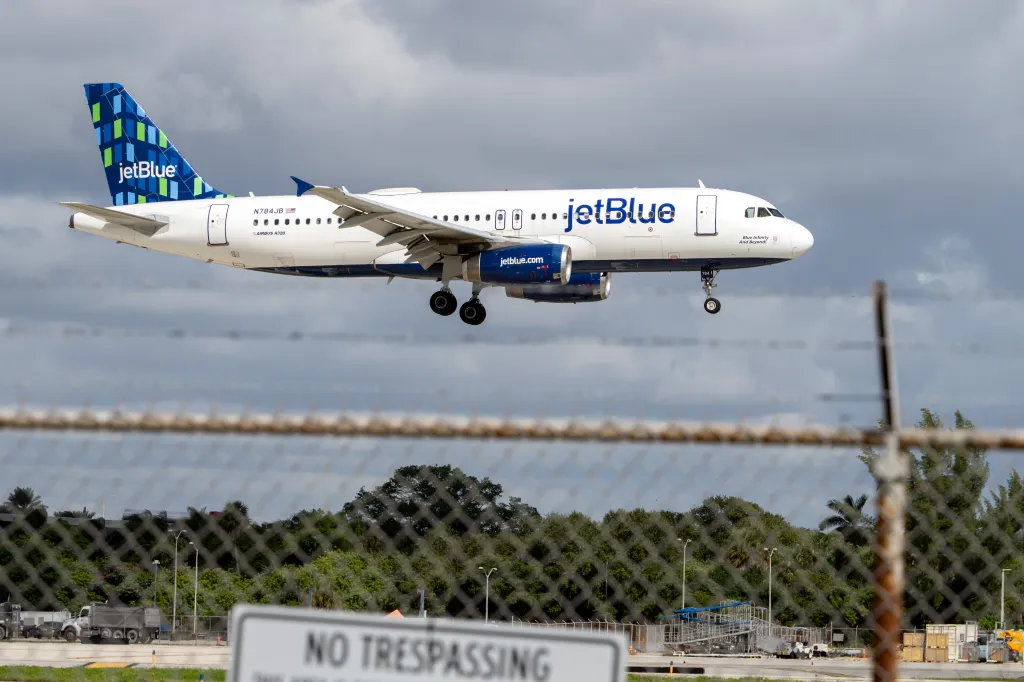 A JetBlue airplane landing at Fort Lauderdale-Hollywood International Airport.