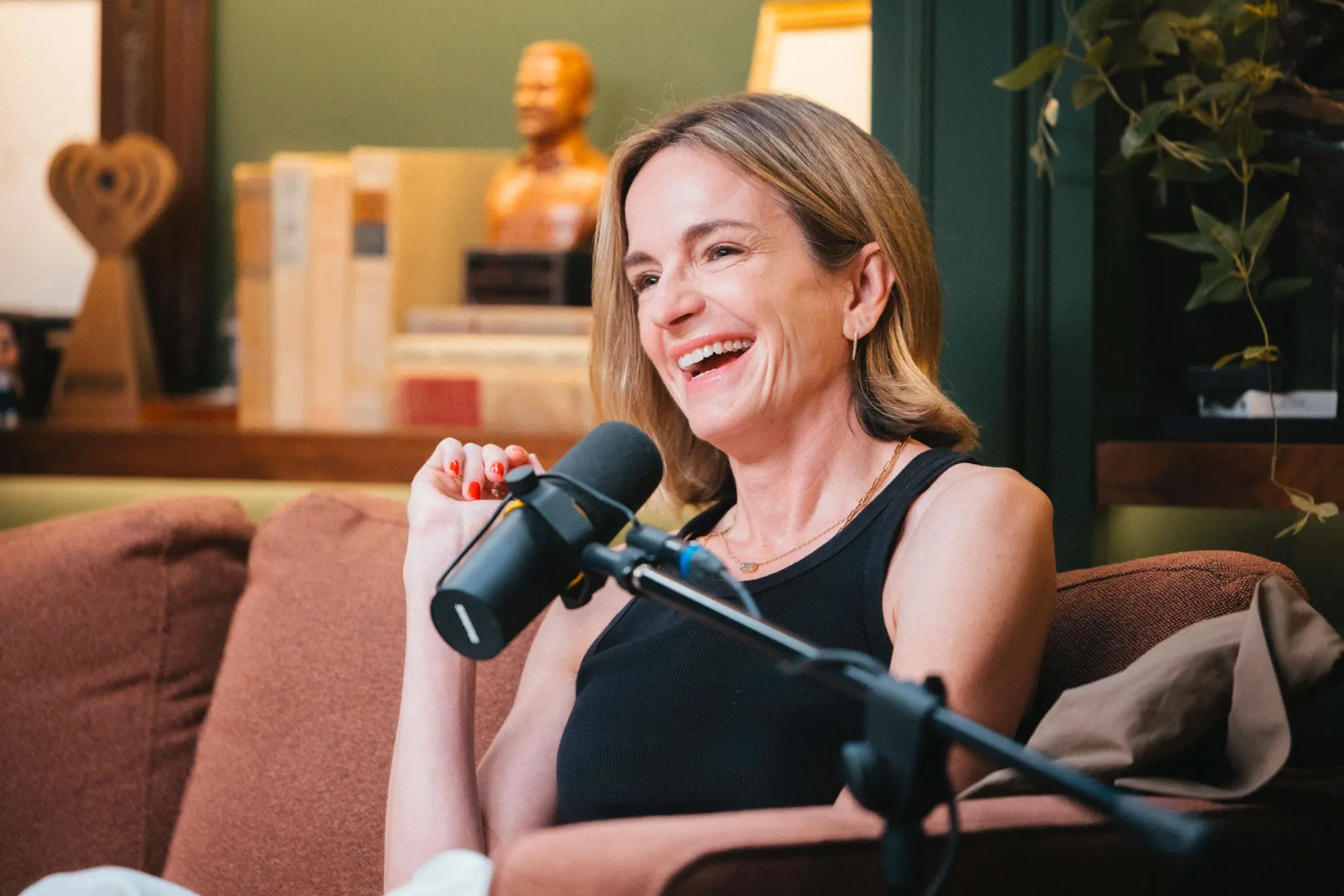 Molly McNearney laughing during a podcast interview.
