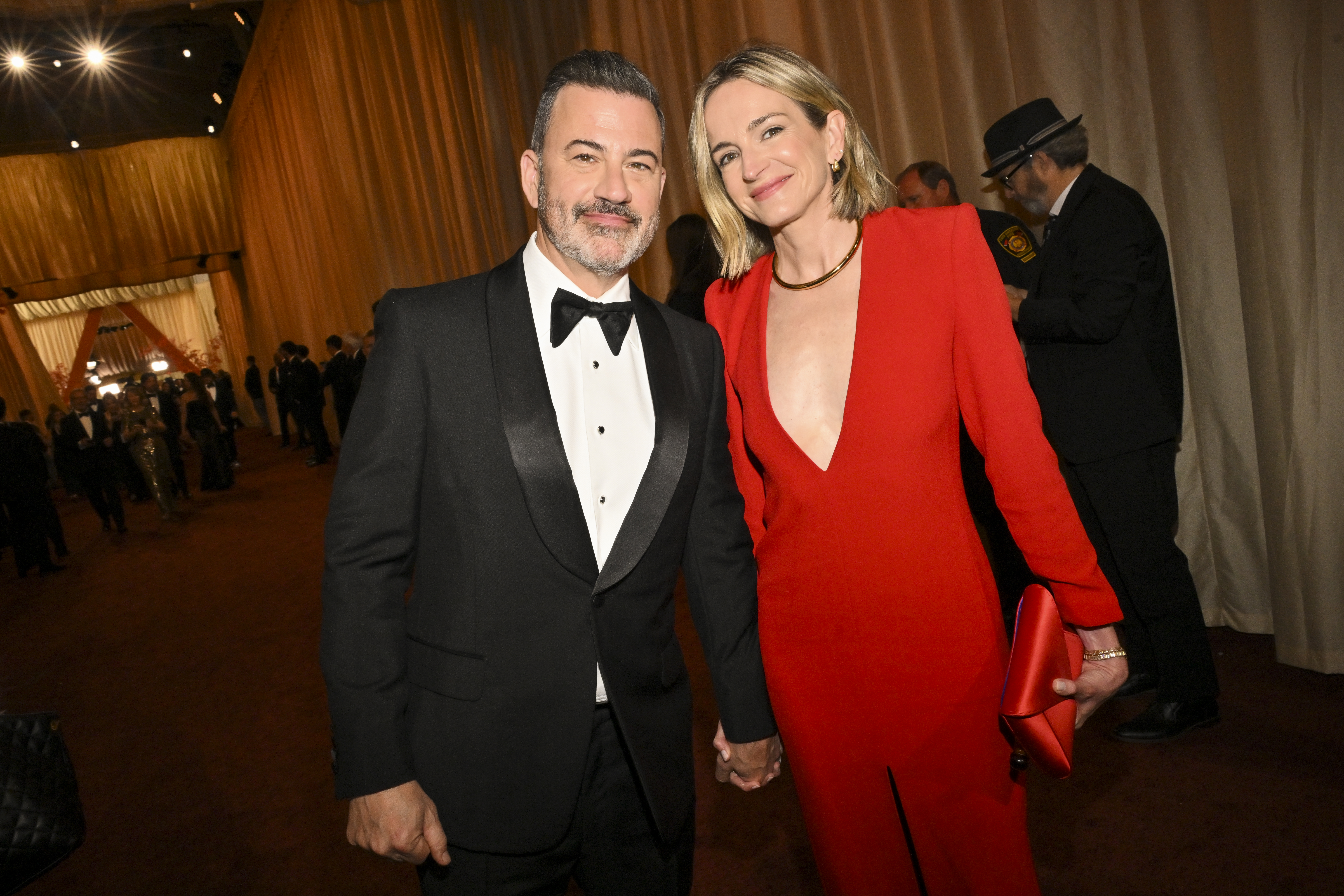 Jimmy Kimmel and Molly McNearney holding hands at the 98th Annual Oscars.