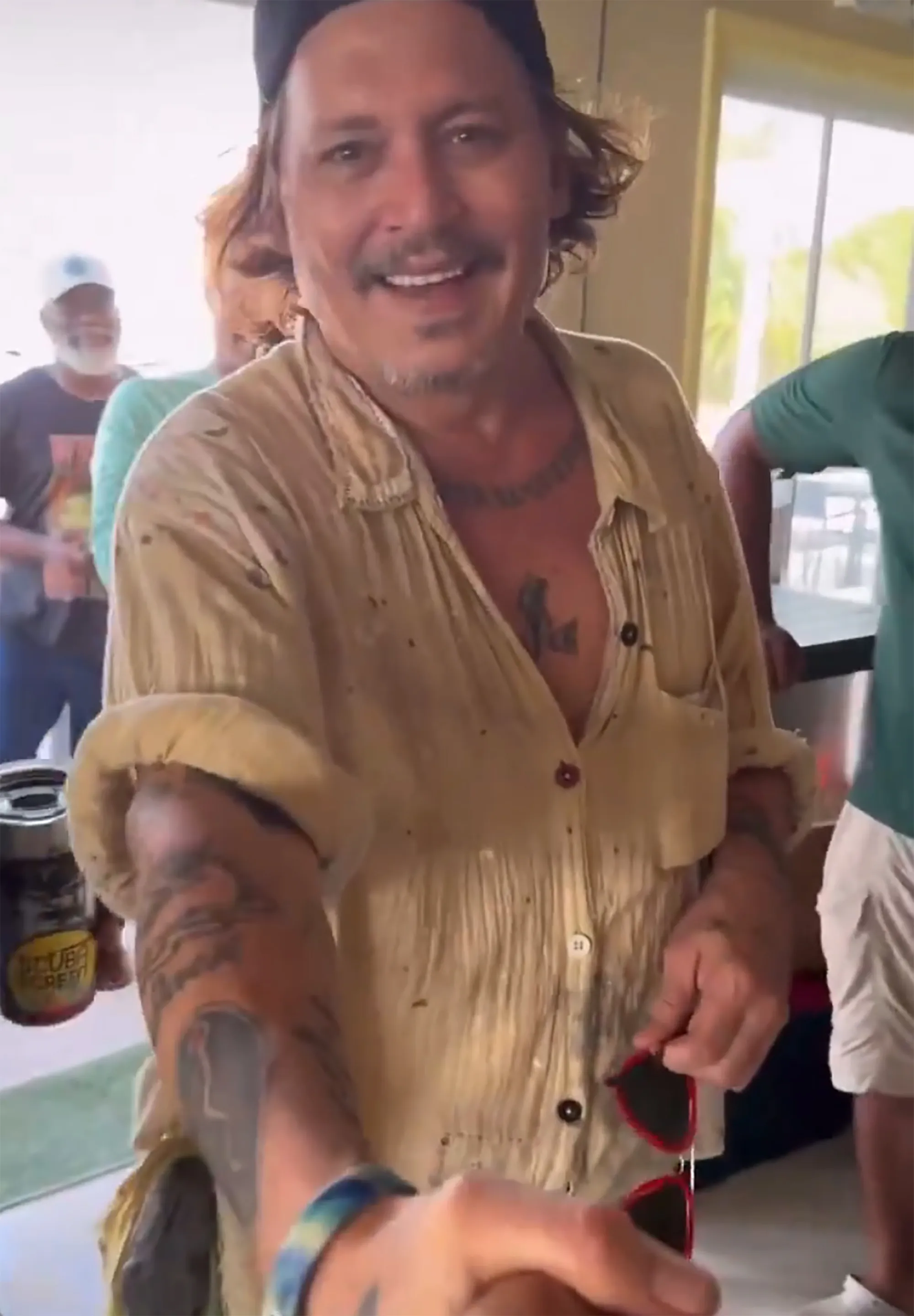 Johnny Depp smiling, revealing pearly white teeth.