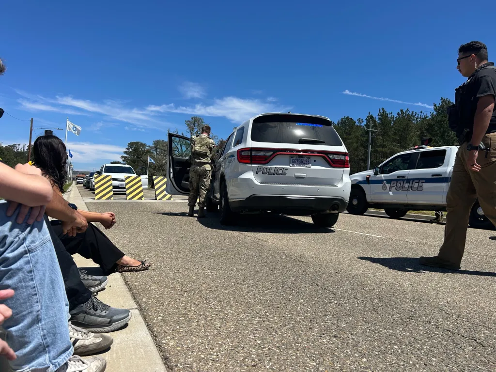 Journalists waiting after being stopped by security officers at Vandenberg Space Force Base.