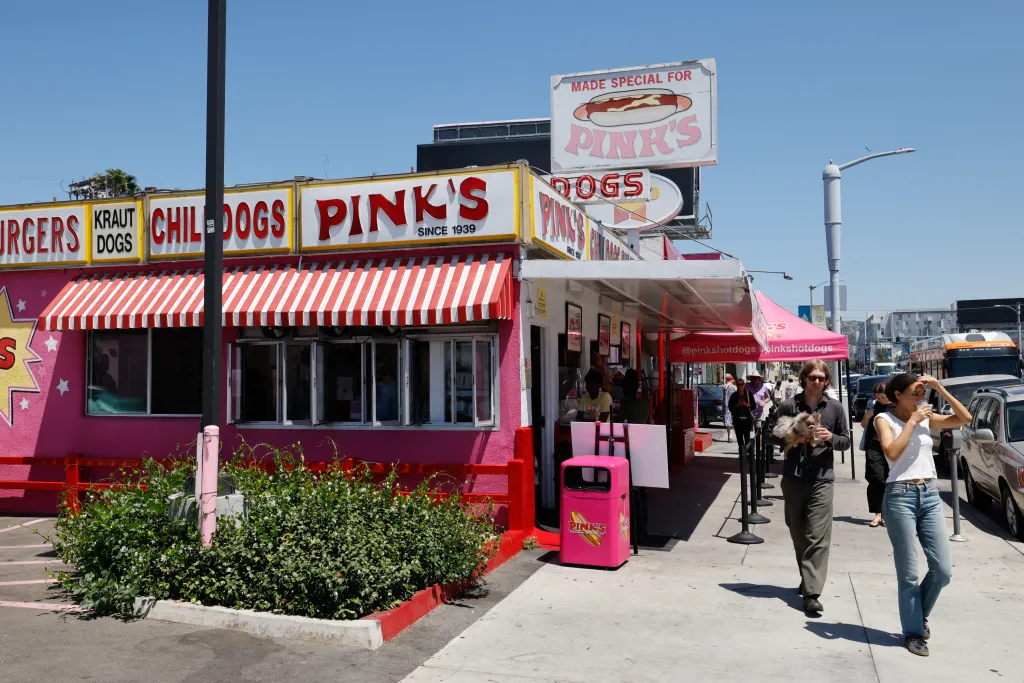 Pink's Hot Dog restaurant in Los Angeles, with customers waiting in line outside.