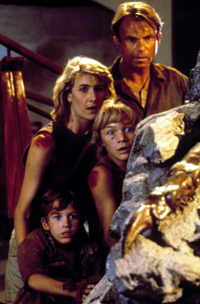 Laura Dern, Sam Neill, Joseph Mazzello, and Ariana Richards looking frightened in Jurassic Park.