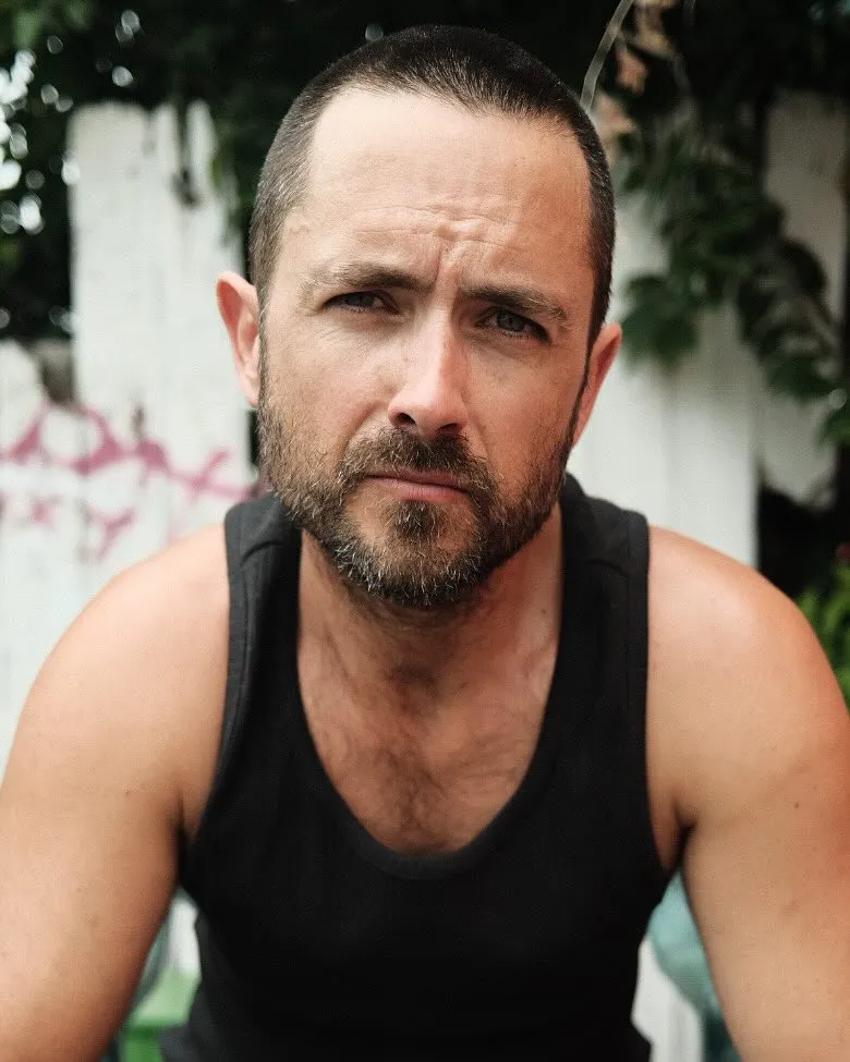 Justin Chatwin looking directly at the camera.