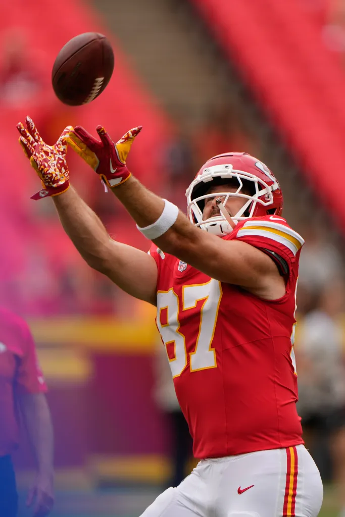 Kansas City Chiefs tight end Travis Kelce catching a football during warm-ups.