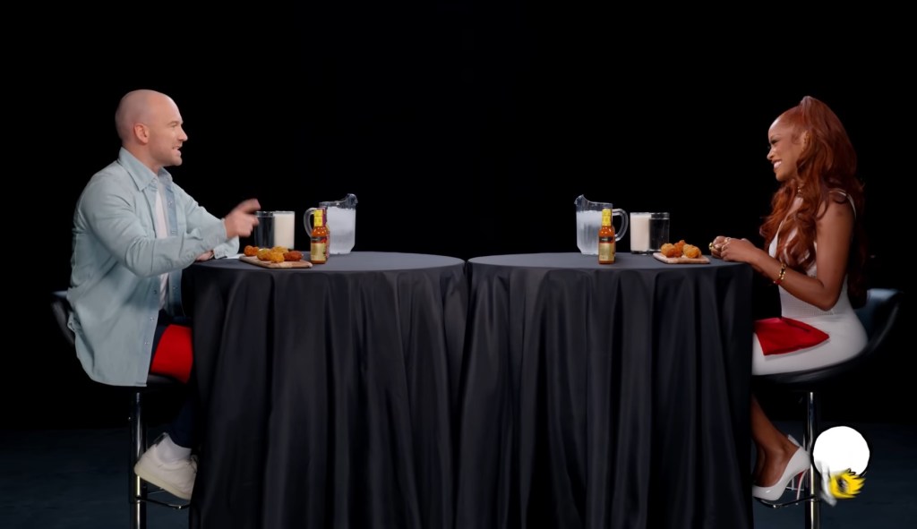 Keke Palmer sitting across from Sean Evans on Hot Ones.