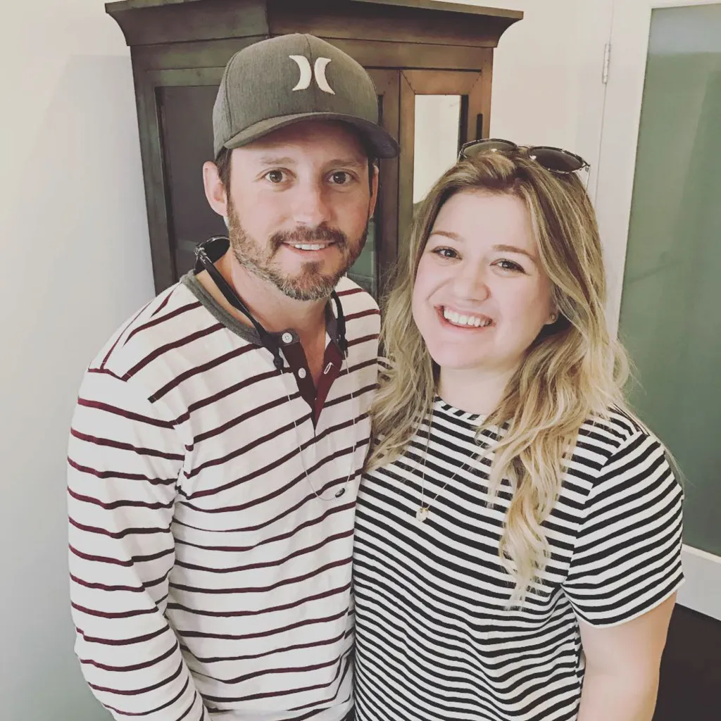 Kelly Clarkson and Brandon Blackstock smiling at the camera.