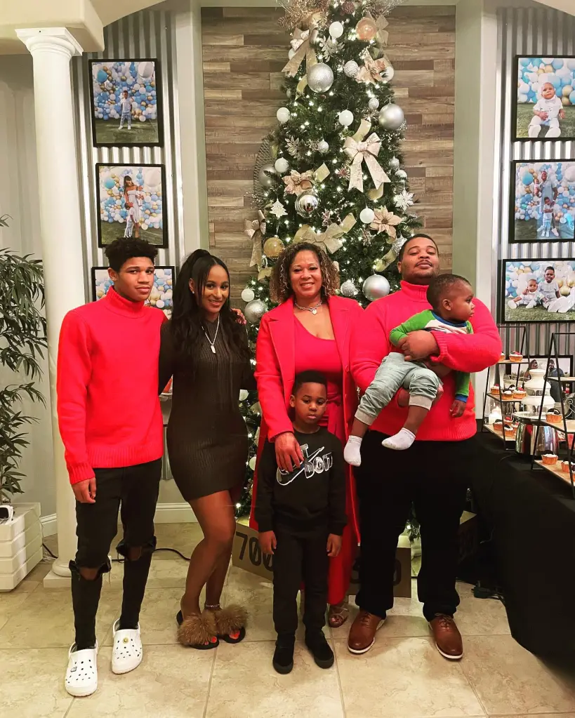 Keshia Thomas pictured with her family in front of a Christmas tree.