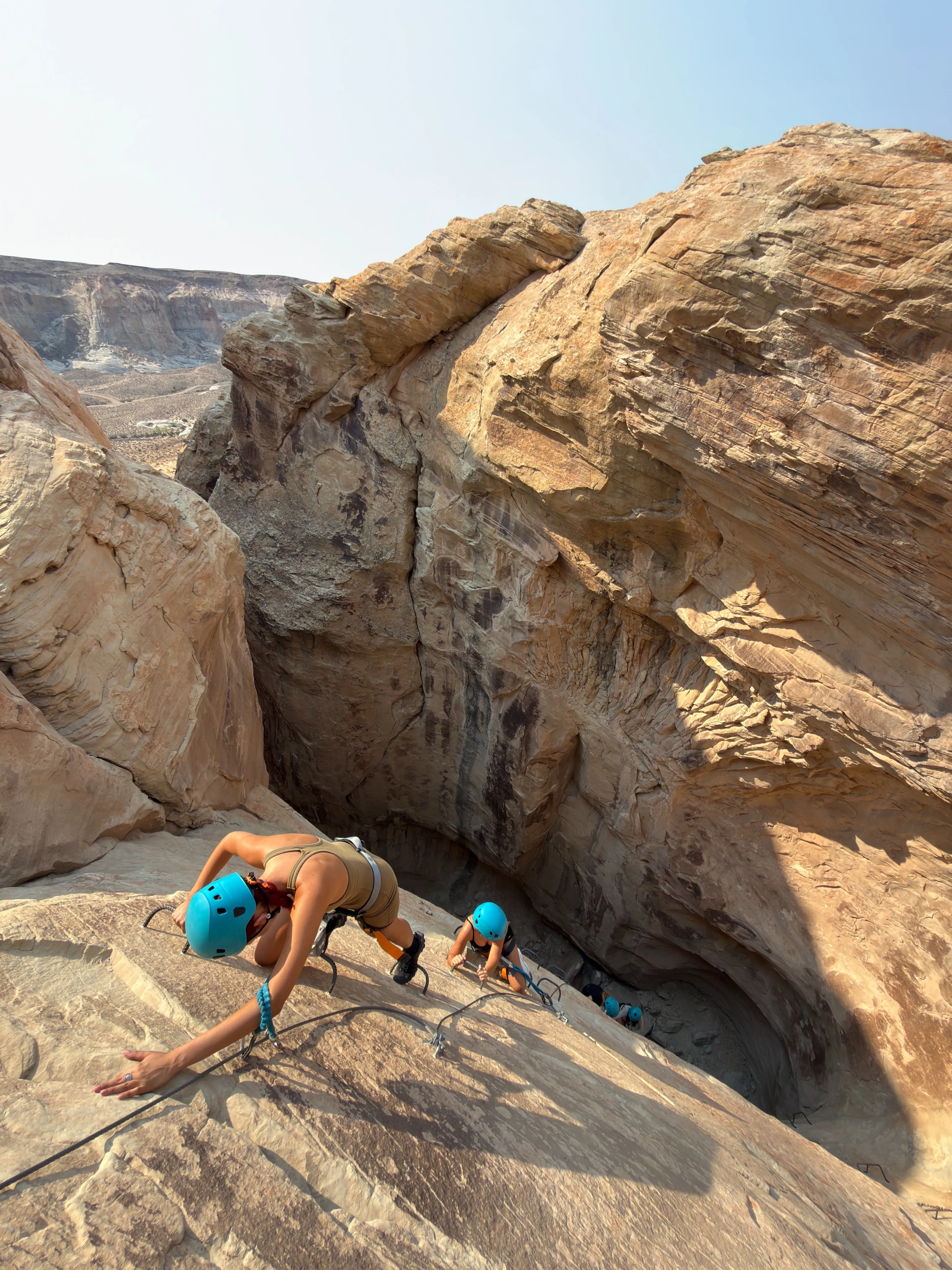 People rock climbing in a canyon.