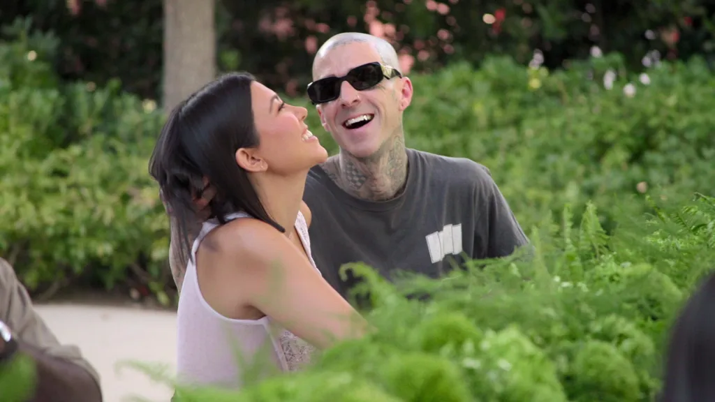 Kourtney Kardashian and Travis Barker laughing together.