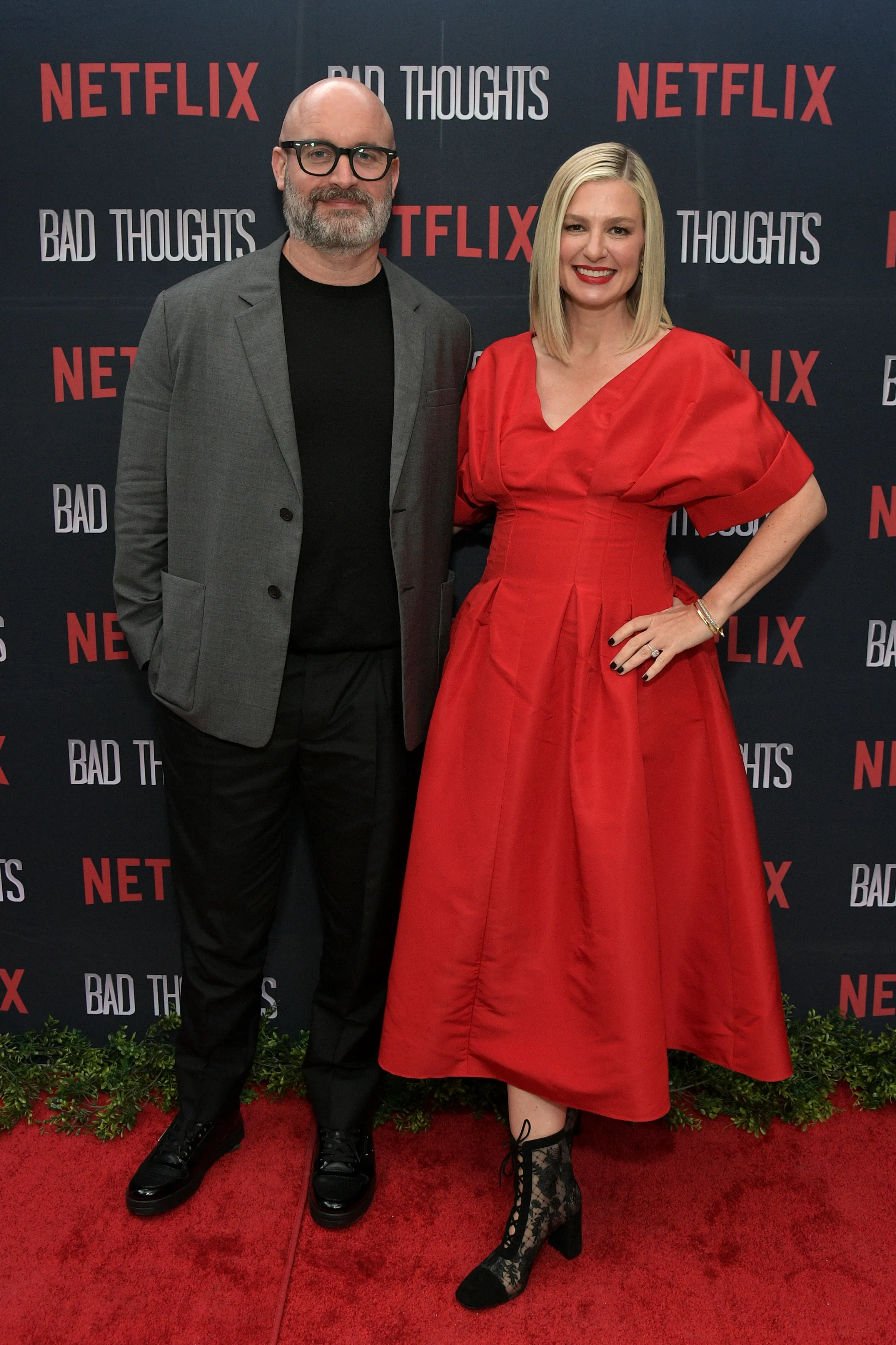 Tom Segura and Christina Pazsitzky posing on the red carpet at the LA premiere of Tom Segura's Netflix series 'Bad Thoughts'.