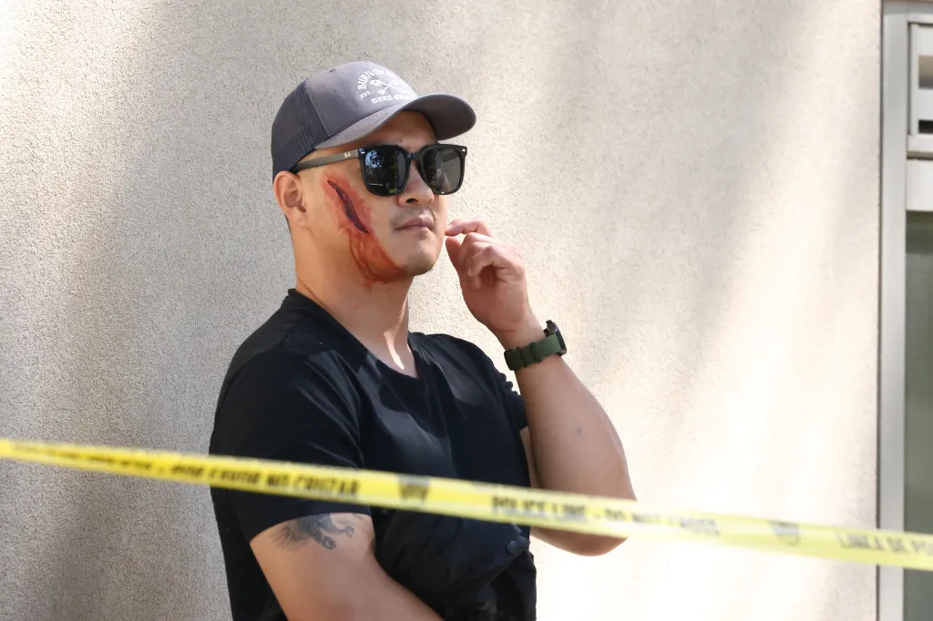 Man with theatrical wound on his face from a SWAT drill.