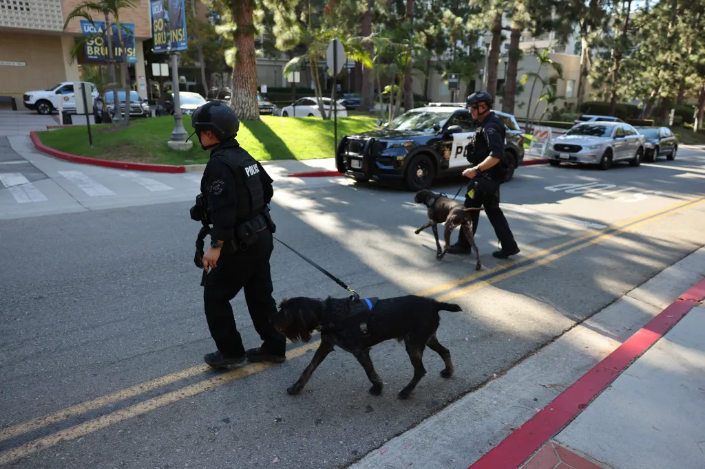 Two police officers with K-9 units participate in an LAPD SWAT drill at UCLA.