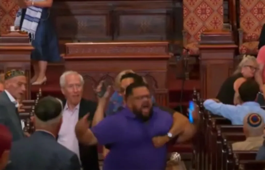 Larry Montes being taken into custody inside Central Synagogue.