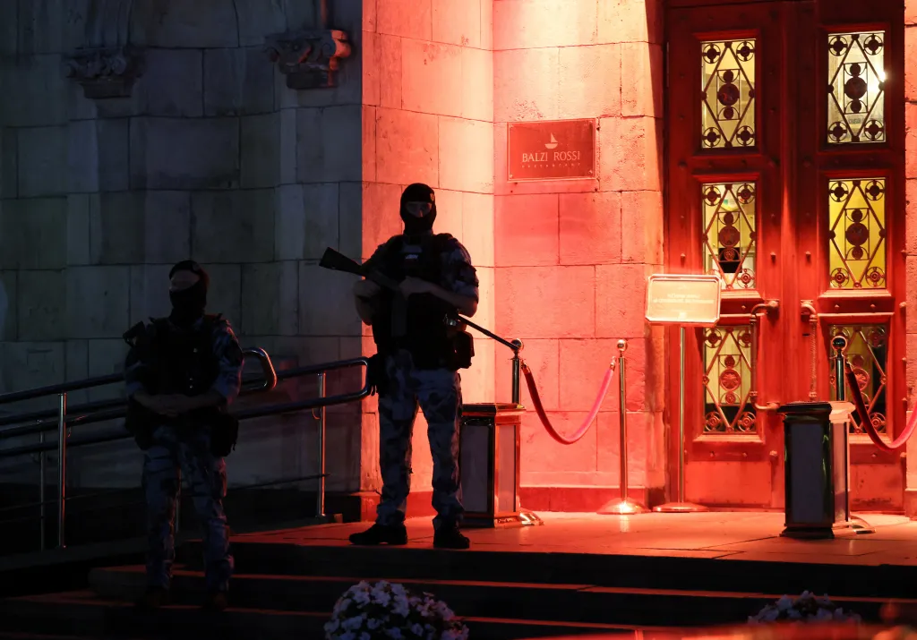 A police officer stands guard outside a restaurant where an explosion killed three in Moscow on Aug. 1, 2026.