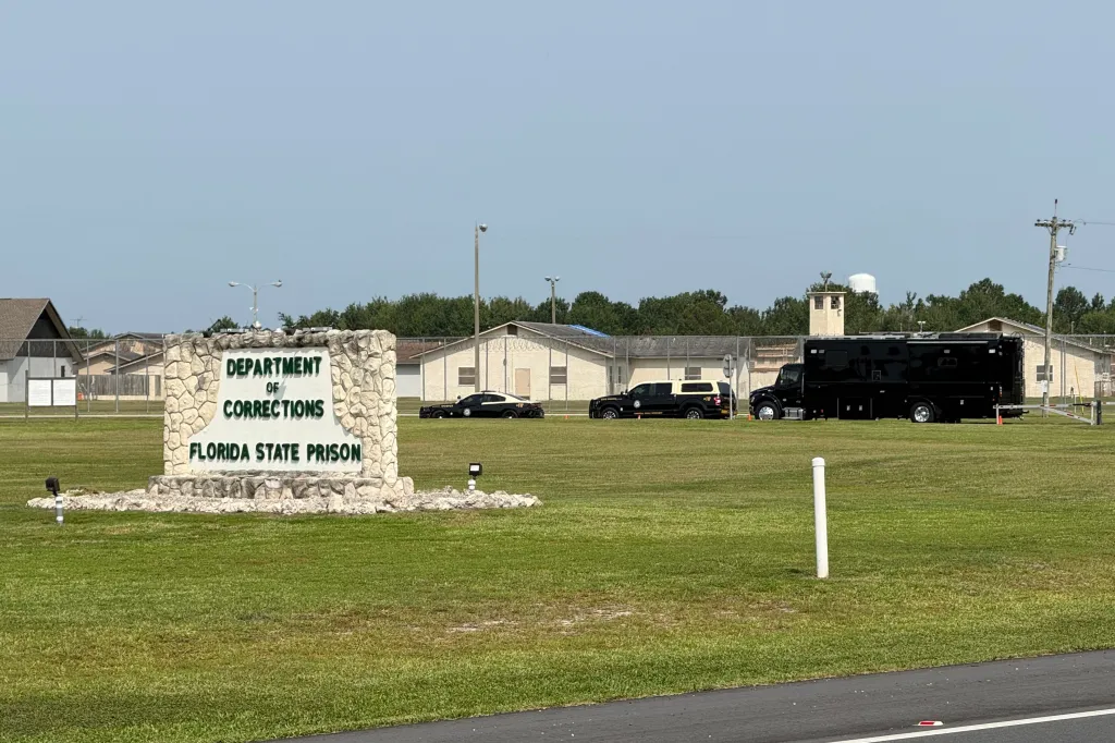 Law enforcement vehicles parked outside Florida State Prison.