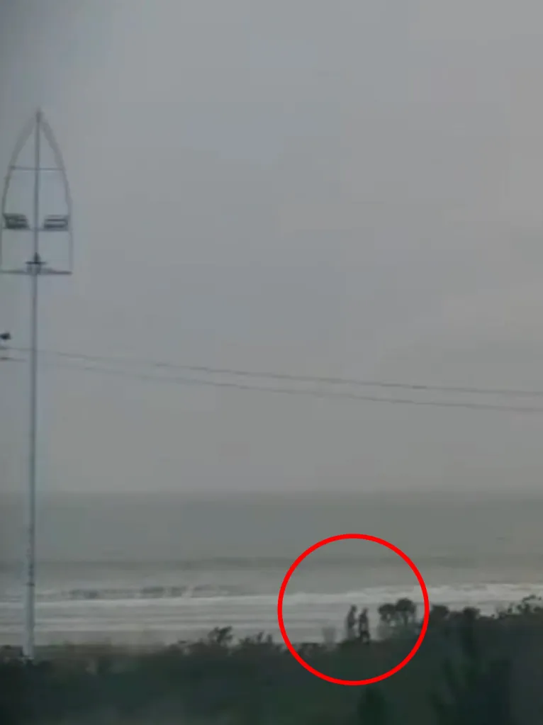Two people on Praia da Pinheira beach, one of whom was struck by lightning.