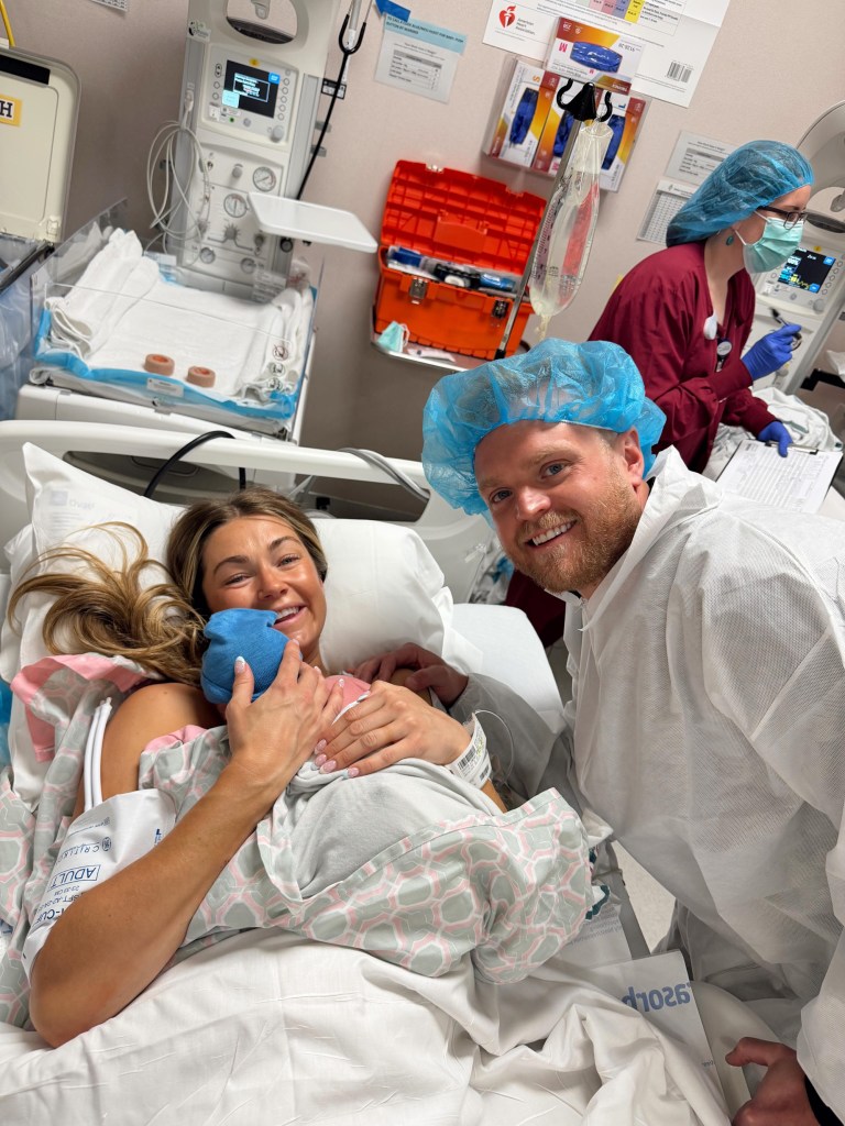 Lindsay Arnold and her husband Sam Cusick with their newborn in a hospital.